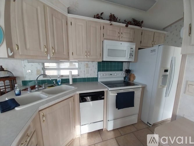 A kitchen with wooden cabinets and a white fridge.