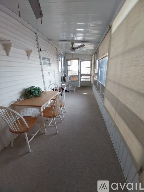 A room with a table and chairs in it.
