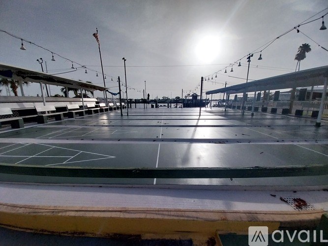A tennis court with a sunny sky in the background.