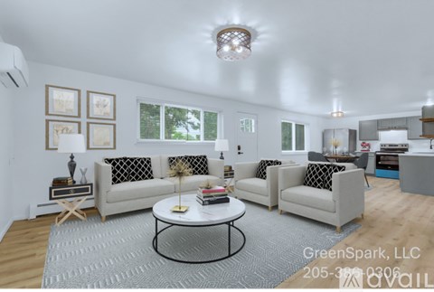 A living room with a white sofa set and a grey rug.