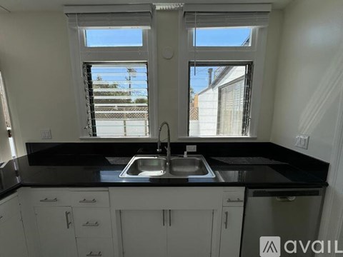 A kitchen with a sink and a window.
