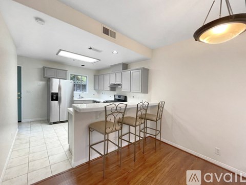 A kitchen with a dining table and chairs.