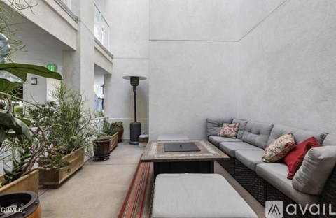 A living room with a grey couch and a coffee table.