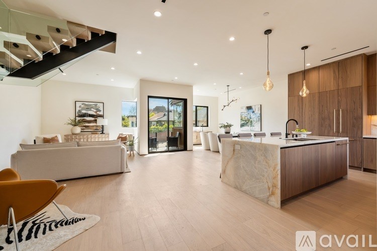 A modern living room with a staircase leading to the upper floor.