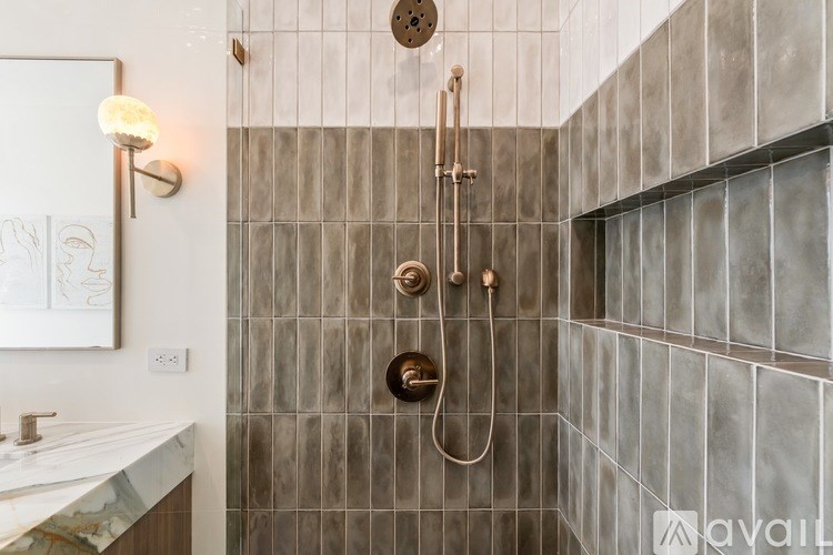 A bathroom with a shower and a sink.