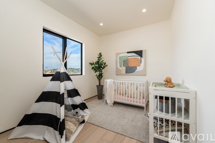 A baby's room with a crib and a teddy bear.