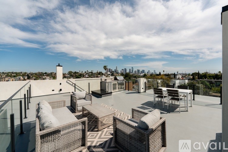 A rooftop patio with a view of the city skyline.