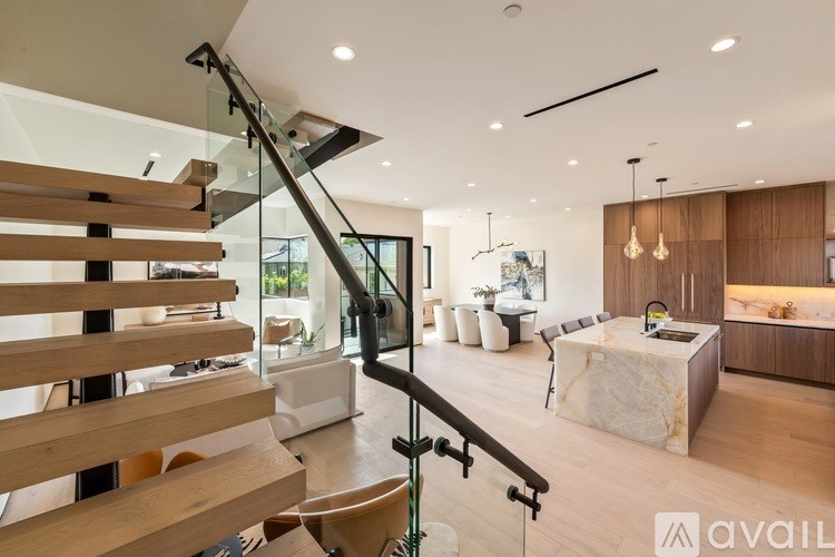 A modern interior with a staircase and a bedroom.