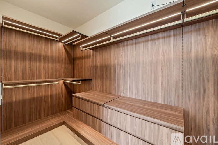 A wooden bench with a shelf underneath it.