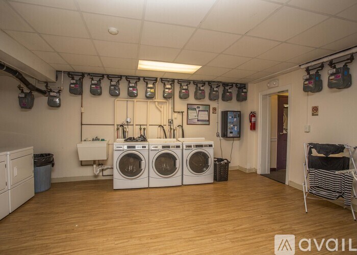 A laundry room with washers and dryers and a sign that says "available".