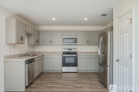 A kitchen with a white oven and refrigerator.