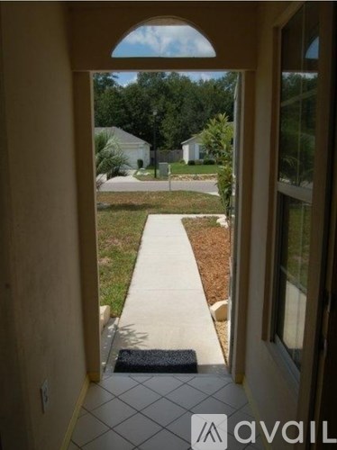 A view from a doorway looking out to a residential street.