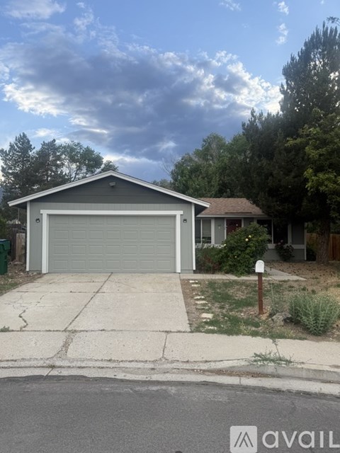 A house with a garage is for sale.