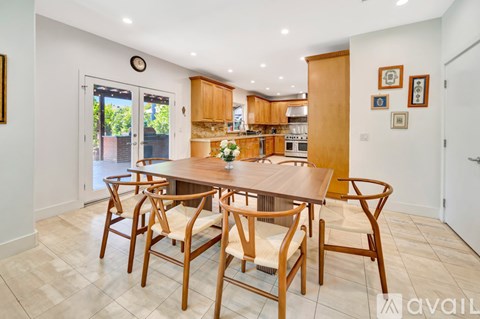 A dining room with a table and chairs.