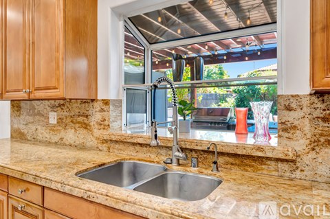 A kitchen with a sink and a window.