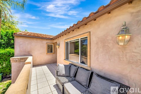 A patio area with a couch and a table.