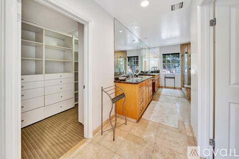 A kitchen with a bar stool in front of it.