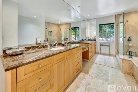 A bathroom with two sinks and a large mirror.