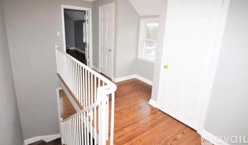A white staircase with a wooden floor.