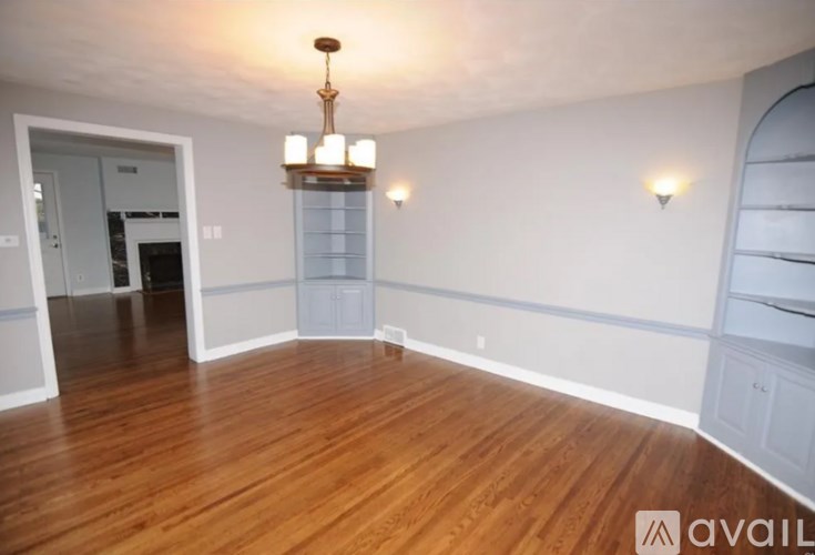A room with wooden floors and a chandelier.