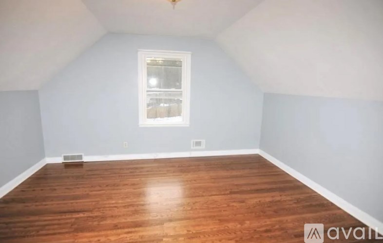 A room with wooden floors and a window.