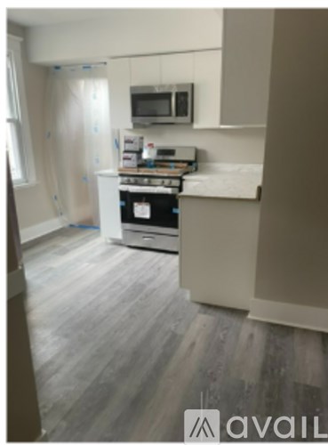 A kitchen with a stove top oven and microwave.