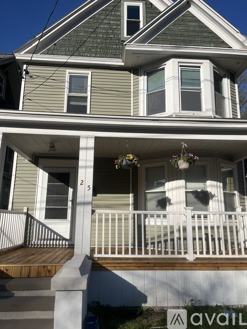 A two story house with a balcony and a deck.