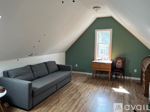 A living room with a grey couch and a wooden table.