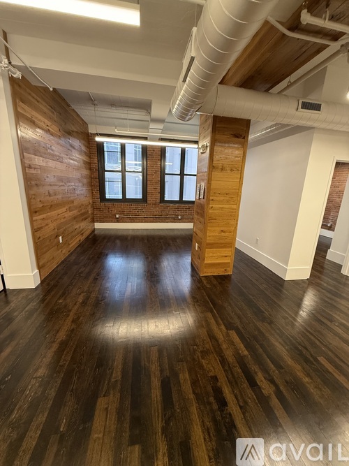A room with wooden floors and a window.