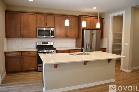 A kitchen with wooden cabinets and a white countertop.