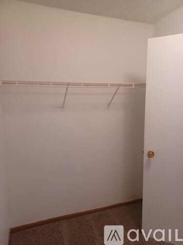 A white door with a gold handle is on the right side of the image.