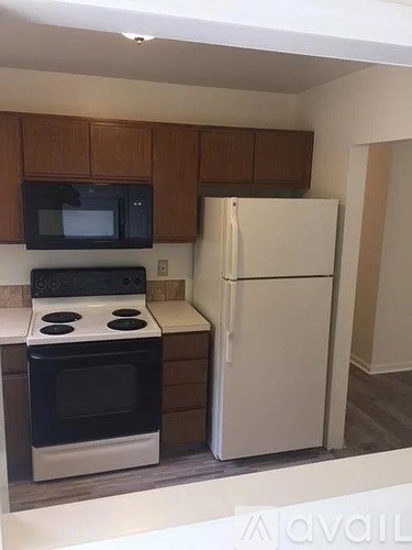 A kitchen with a black stove and white refrigerator.