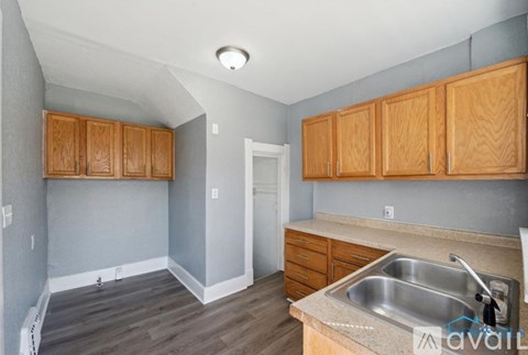 A kitchen with wooden cabinets and a sink.