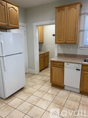 A kitchen with a white refrigerator and a white dishwasher.