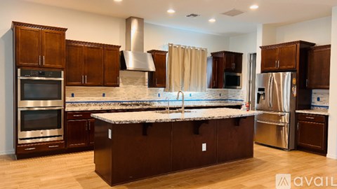 A kitchen with wooden cabinets and stainless steel appliances.