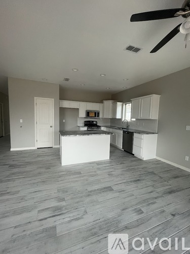 A spacious kitchen with a white island in the middle.