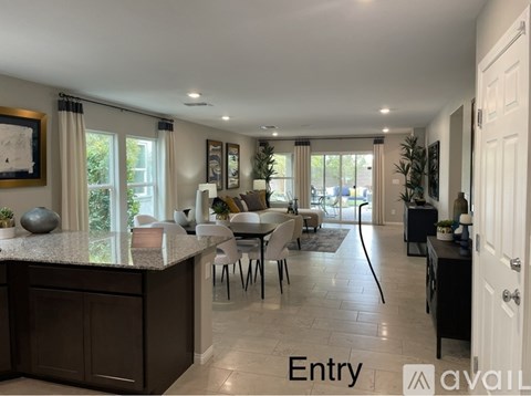 A modern kitchen with a dining area and a view of the backyard.