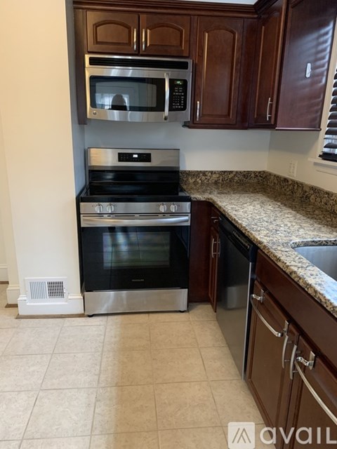 A kitchen with a stainless steel oven and microwave.