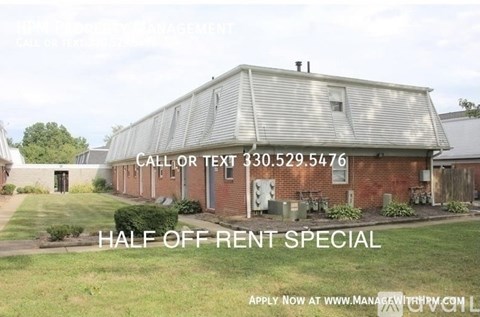 A building with a sign offering a half off rent special.