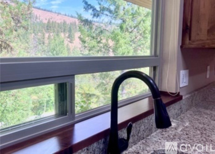 A kitchen sink with a window in the background.