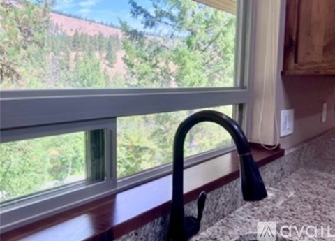 A kitchen sink with a window in the background.
