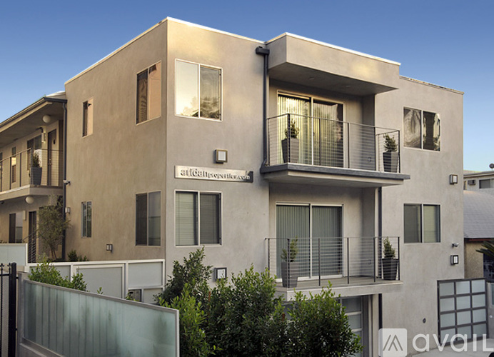 A modern two-story house with a balcony on the upper floor.