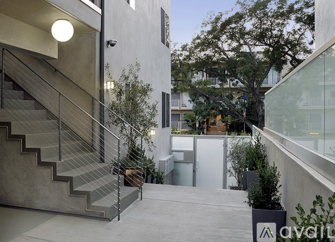 A staircase with a metal railing leads up to a balcony.