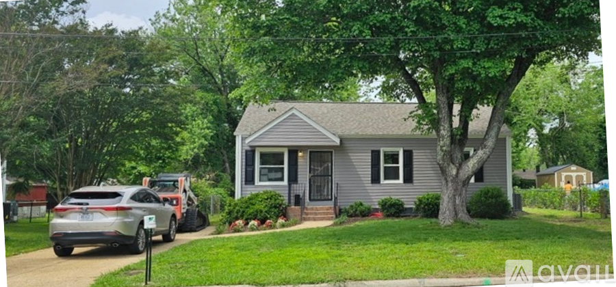 A house with a car parked in front of it.