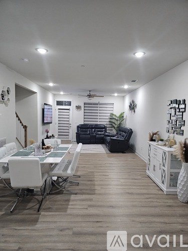 A modern living room with a dining table set up.