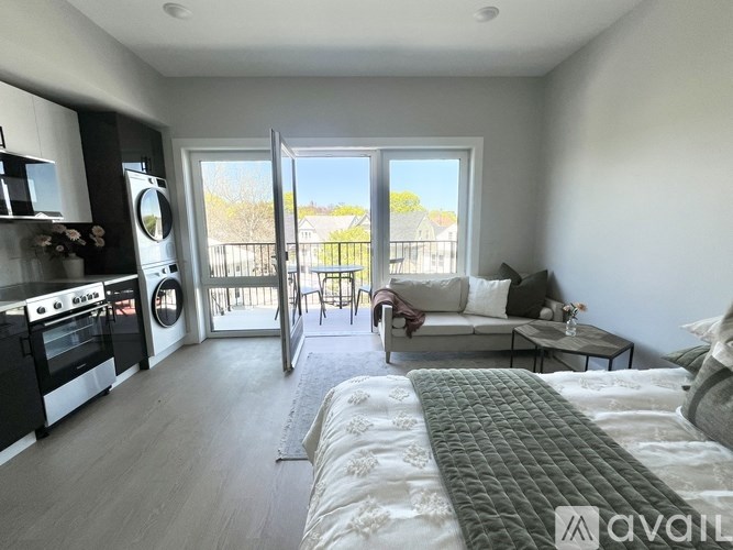 A modern kitchen with a dining area and a balcony.