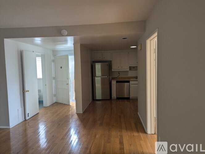 A room with a window, sliding door, and a wall-mounted air conditioner unit.