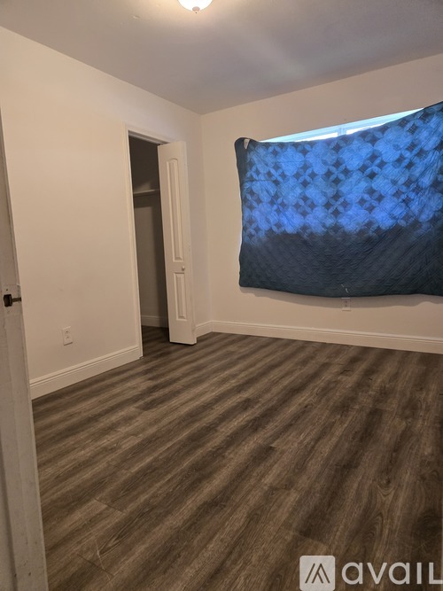 A living room with a couch, chair, and a floor lamp.