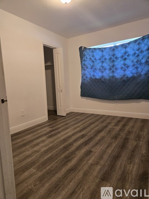 A living room with a couch, chair, and a floor lamp.
