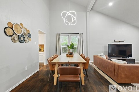 A modern dining room with a wooden table and chairs.